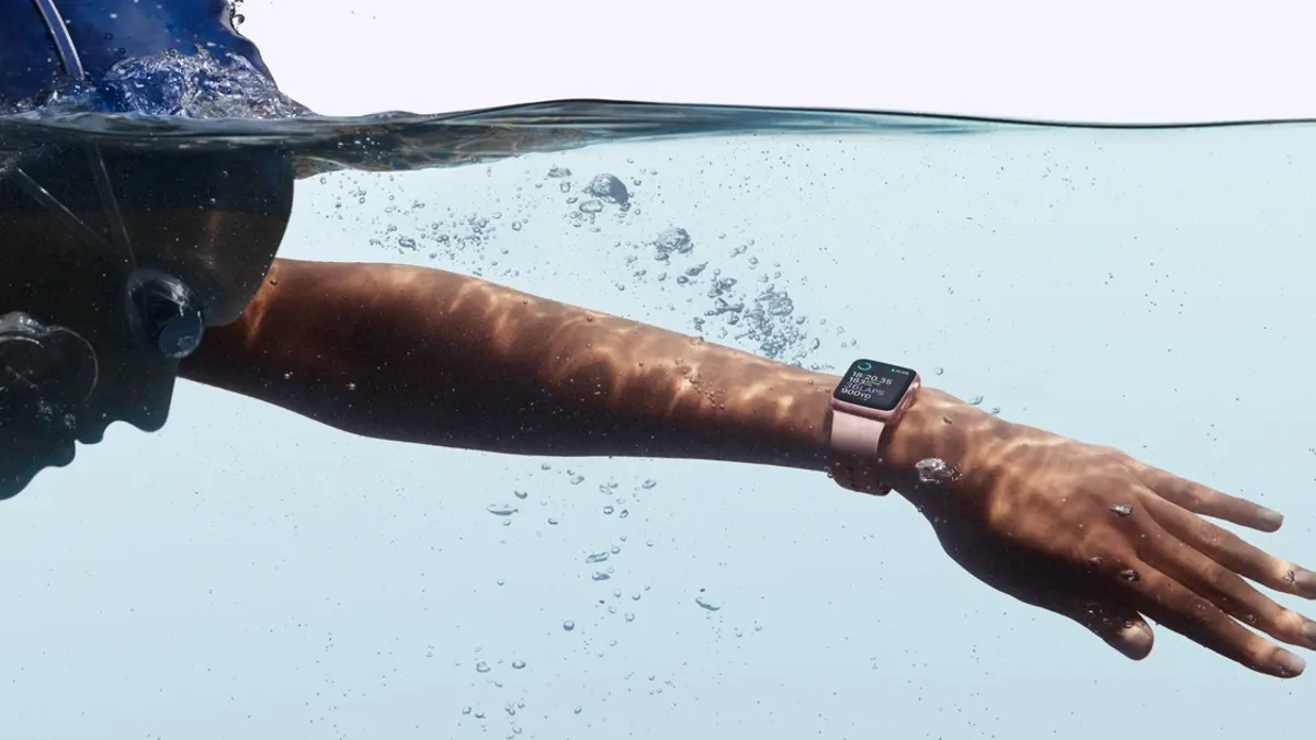 نمایی از یک شناگر به همراه ساعت هوشمند ضد آب بر روی دستش درون آب!